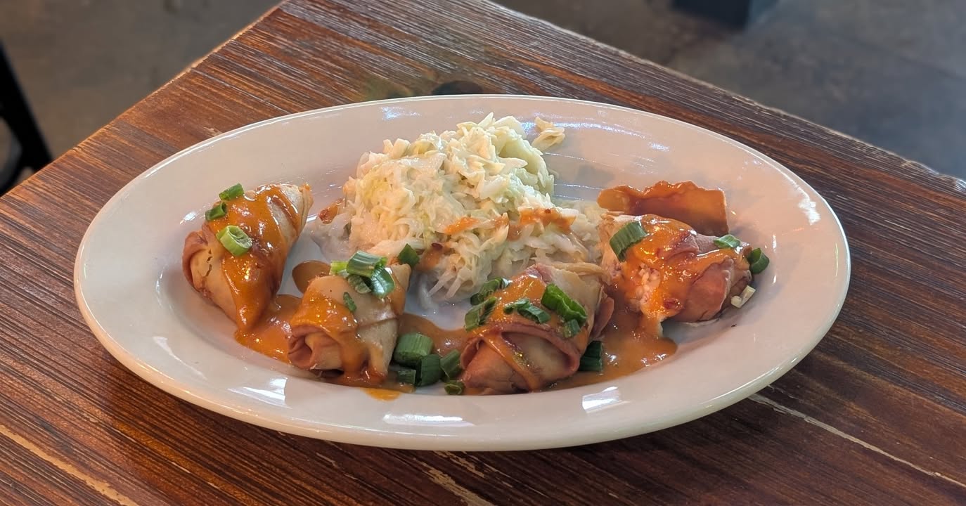 Featured Chef Special:  Two egg rolls filled with house-smoked corned beef, creamy melted Swiss cheese, green onions, and sauerk...